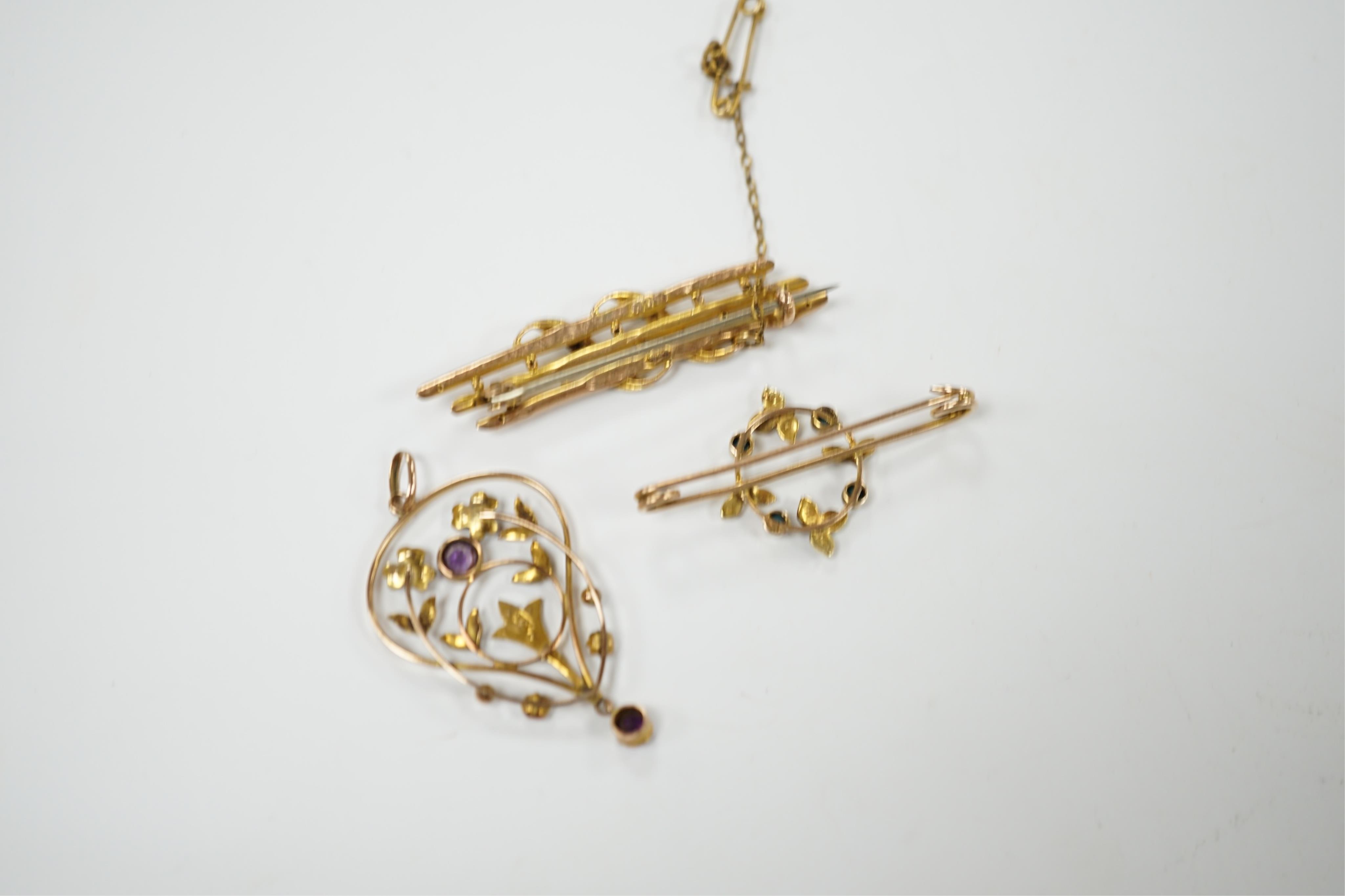 An Edwardian 15ct, turquoise and seed pearl set brooch, 38mm, one other similar yellow metal brooch and a 9ct, amethyst and seed pearl set drop pendant, gross 6.8 grams. Condition - poor to fair